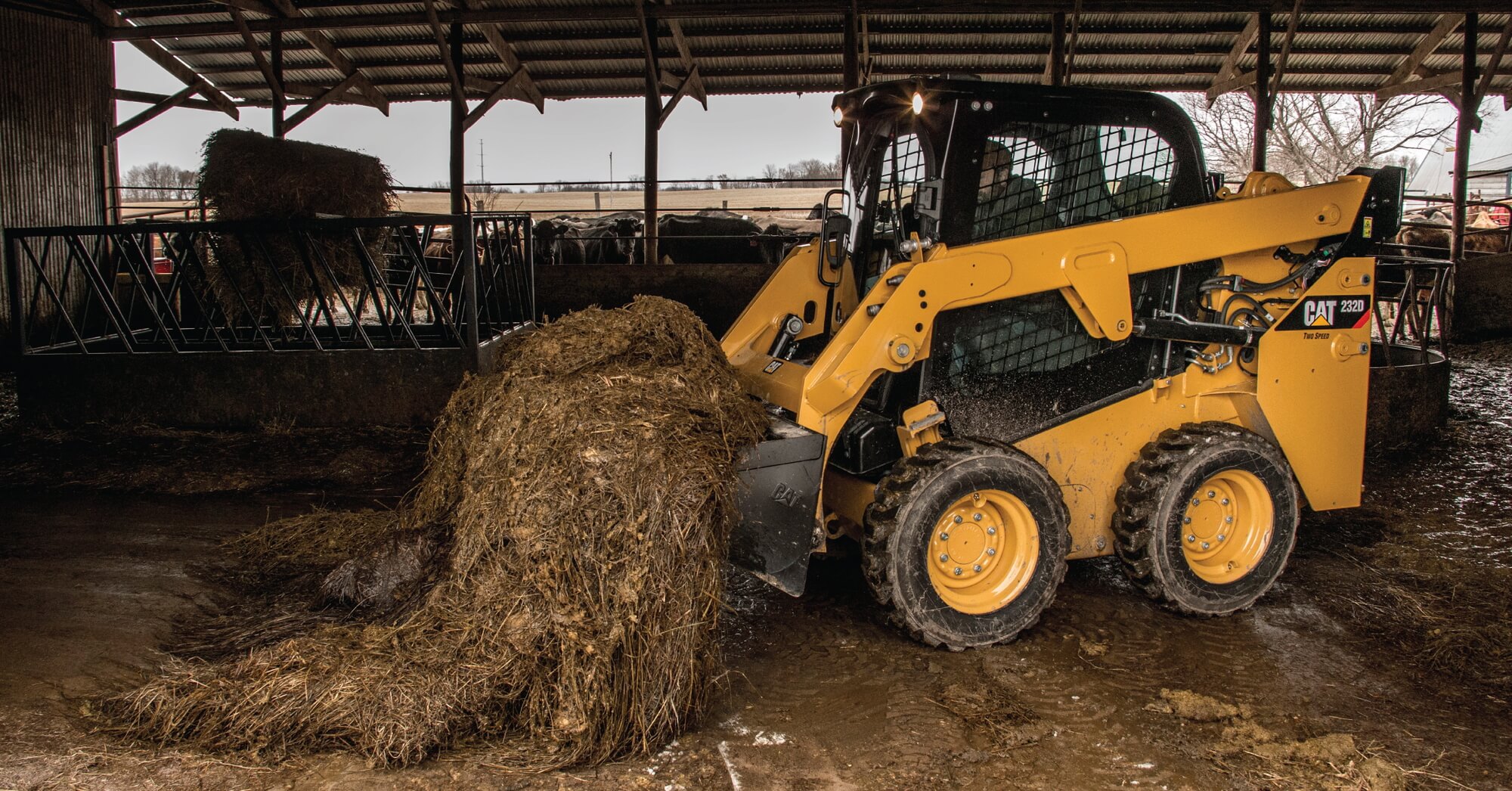 Cat skid steer loader moving hay